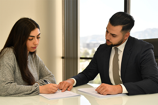 Lawyer at Equate Law Firm going over documents with a client.